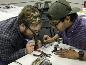 Students soldering electronics