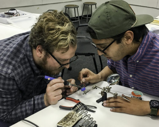 Students soldering electronics