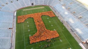 Aerial photo of a Letter T made of people on football