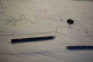 Pencils lying on top of a sketched map