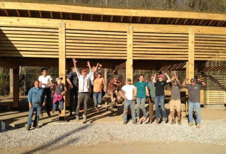 The team in front of the structure celebrating its completion.