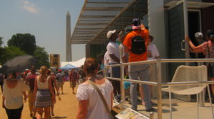 People touring the house on the Washington Mall with the Washington Monument visible in the background.