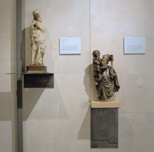 statues on wall platforms