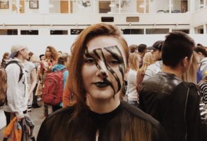 Student's face is painted for Thrift fashion show.