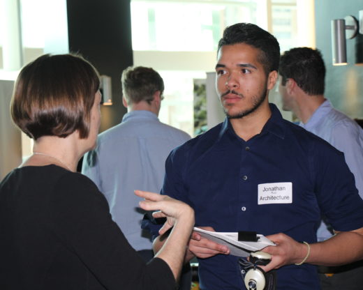 Male student talks with professional at Career Day