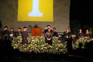 A female student being hooded during a University of Tennessee graduation ceremony.