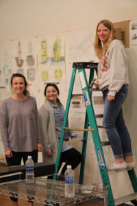 students climbing ladder in classroom