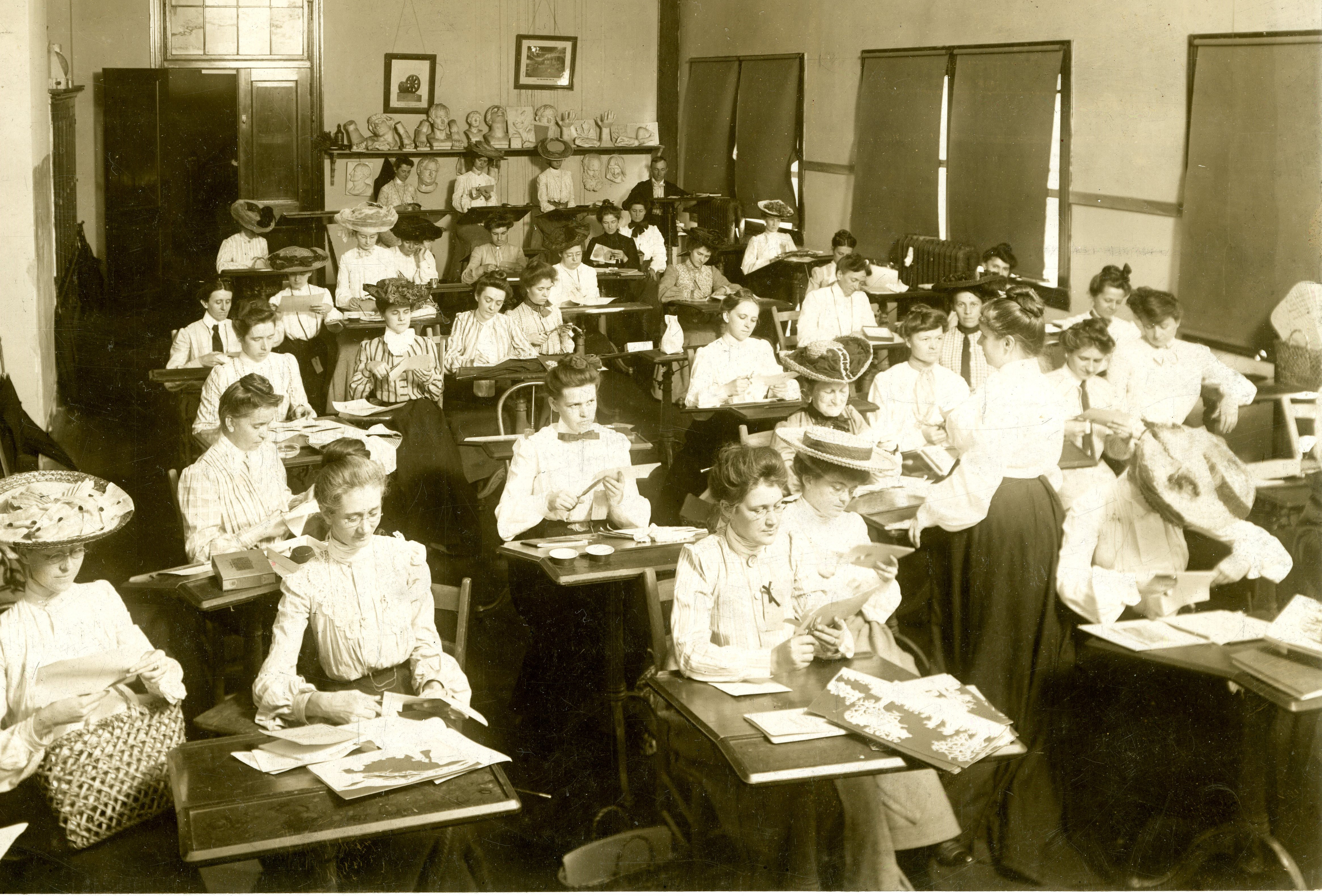 Black-and-white image of female students in the early 1900s during design class.