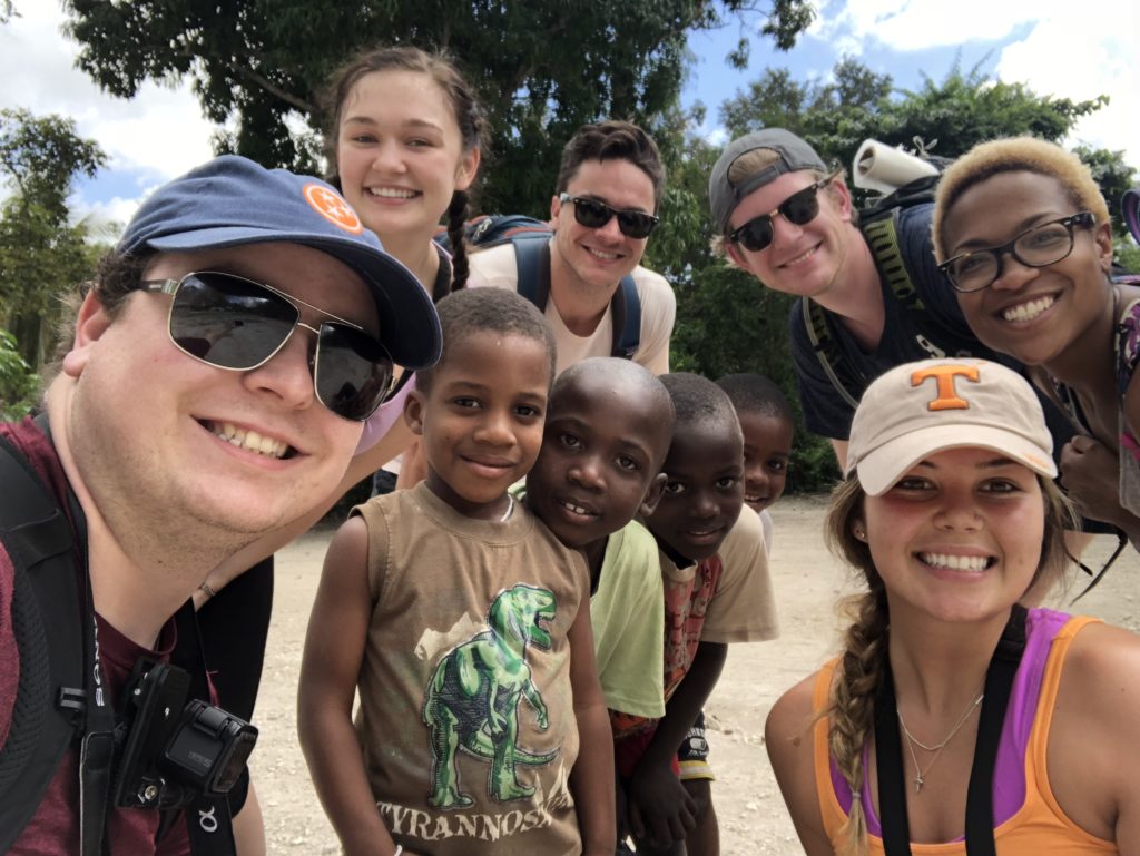 Students take a selfie with children in Haiti