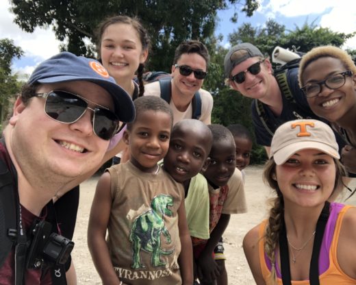 Students take a selfie with children in Haiti