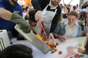 Students being served food at Brag + Boil