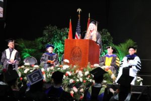 Student speaking at podium at commencement