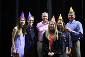 Student and family wearing party hats at Spring Commencement 2018