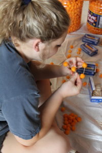 Student building with cheese balls and toothpicks at welcome back day