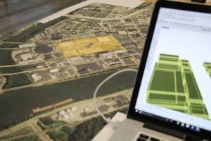 Static shot of model design on laptop with map on the table in studio