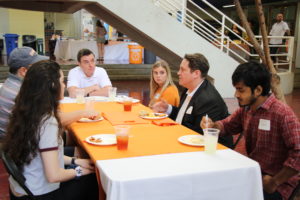 Director Jason Young speaking with students at lunch at open house