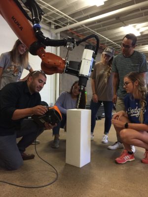 Students with robot in fab lab