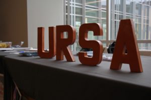URSA block letters on a table at the symposium