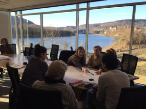 students working in office on river tour