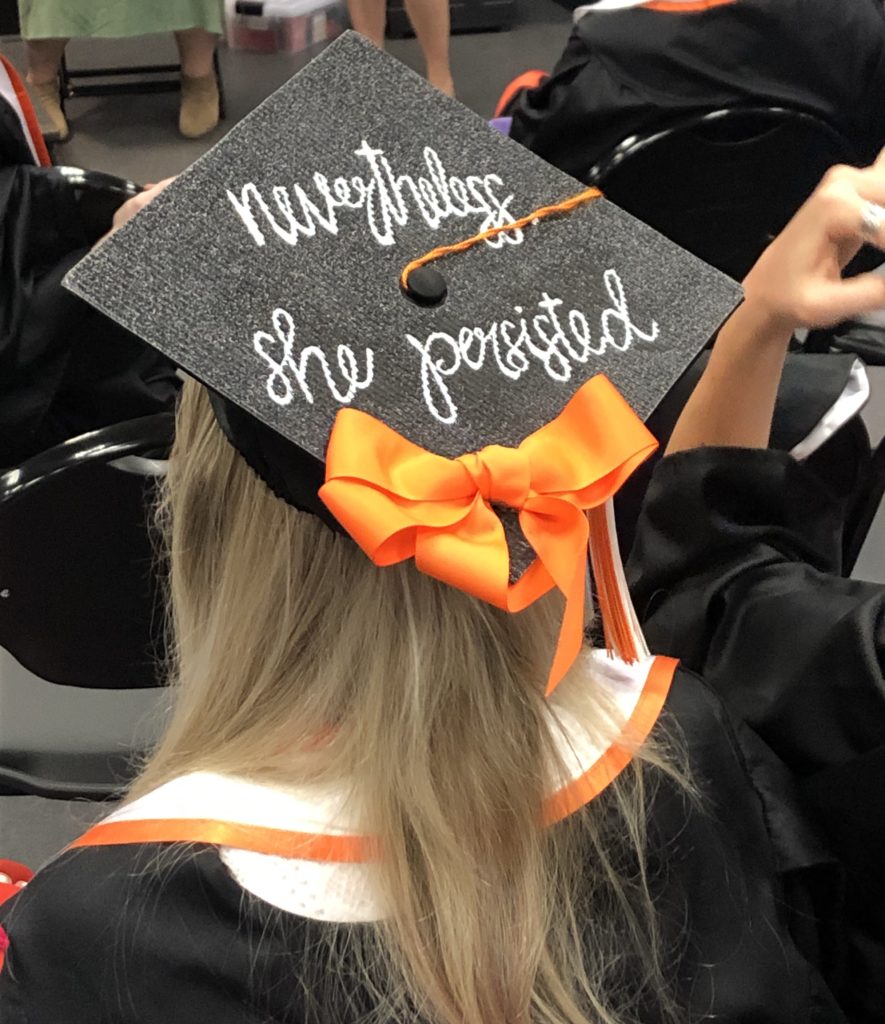 grad cap that says nevertheless she persisted