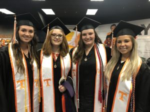students smiling before walking stage