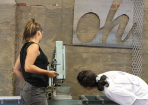 students work to bend metal