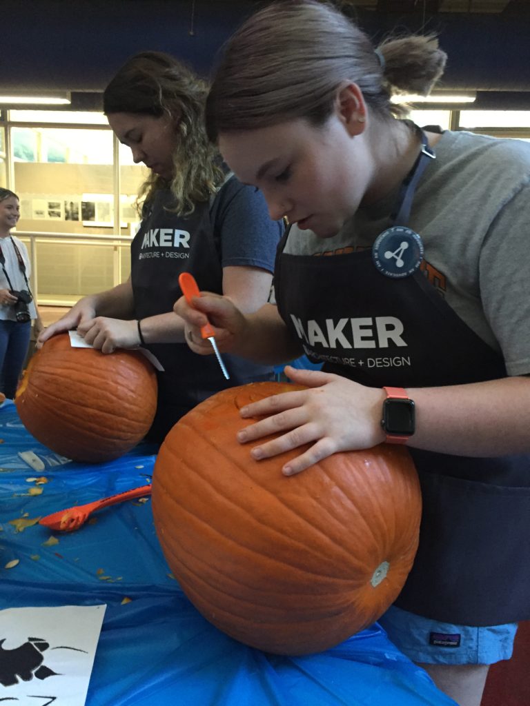 Students carving pumpkins