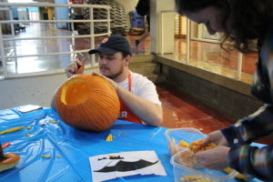Jonathan Winfiele carving pumpkin