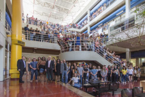 Group shot in atrium of students, faculty, staff