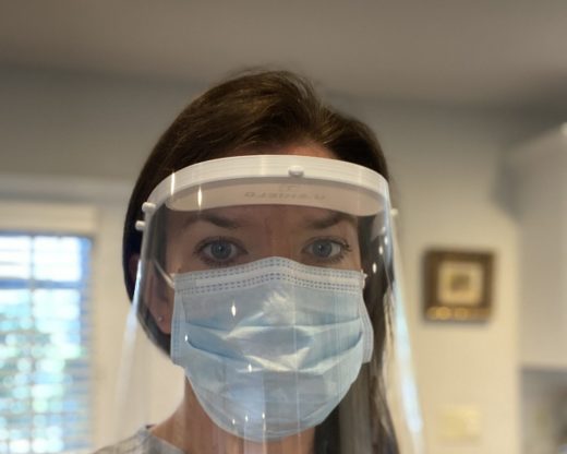female healthcare worker wears face shield