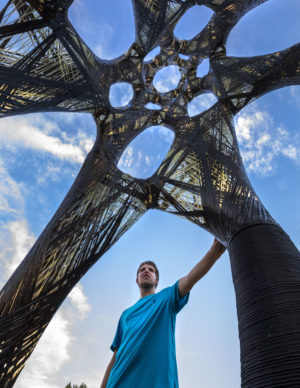 UTK Student standing under Filament Tower