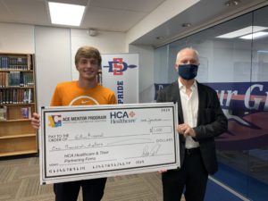 Student, other holding huge check