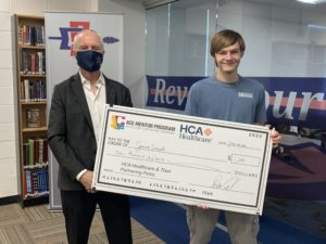 Student, other holding huge check