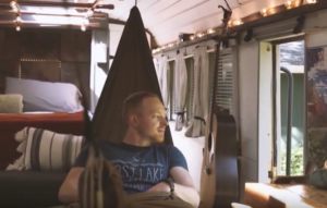 Caleb Brackney in hammock in Roamer bus