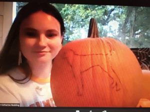 screenshot of student with stenciled pumpkin