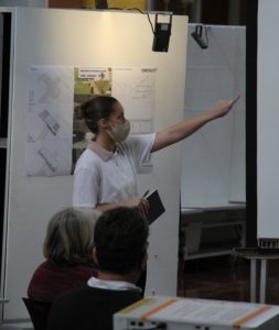 image of student pointing at their project at final reviews