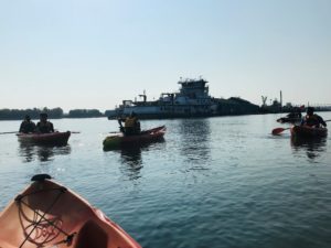 kayaks on the water and a tugboat