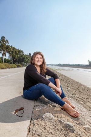 Jessica Henson sitting on a roadside