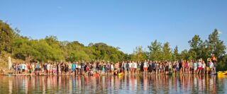 people standing near a lake