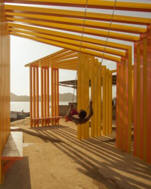 child swinging in outdoor pavilion