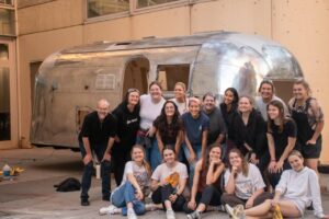 group of people in front of Airstream