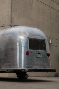 back of Airstream trailer with building in background