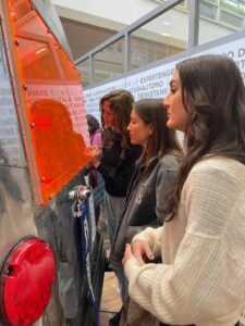 students looking into back window of renovated Airstream trailer