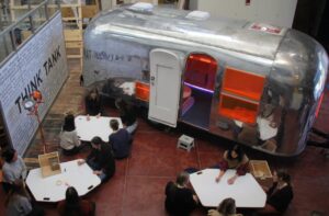 mobile trailer with students sitting at tables in the front