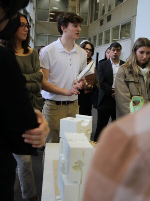 student talking with a model in front of him on the table