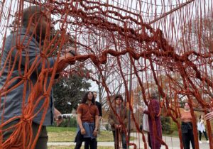 image of a red #D structure outdoors with students looking at it