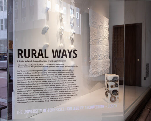 Exterior of the 500 S. Gay Street building with the Rural Ways exhibition. On a glass panel, 'Rural Ways' and the exhibition statement.