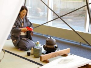 Asian woman demonstrates the traditional Japanese tea ceremony.