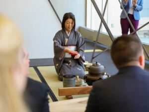 Asian woman demonstrates the traditional Japanese tea ceremony.