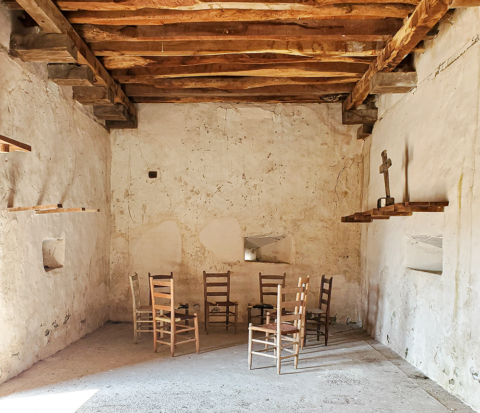Interior of Rancho San José de los Corralitos, Zapata County, Texas. The trapdoor to the roof is in the right-hand corner, and troneras (loopholes) are visible in each of the walls. Photo by Marie Saldaña, 2022.